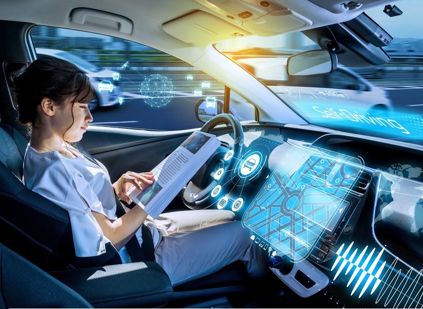 Young,Woman,Reading,A,Magazine,In,A,Autonomous,Car.,Driverless